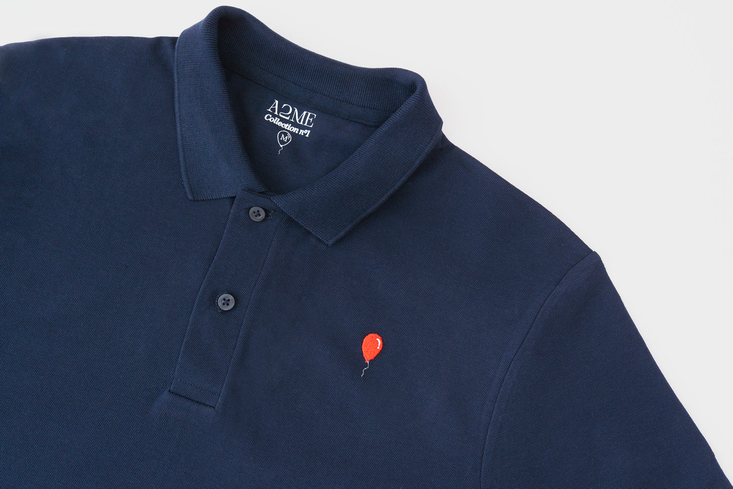 Polo AZUL MARINO globo rojo